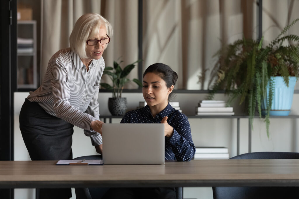 A workplace leader mentoring a young professional in the office.