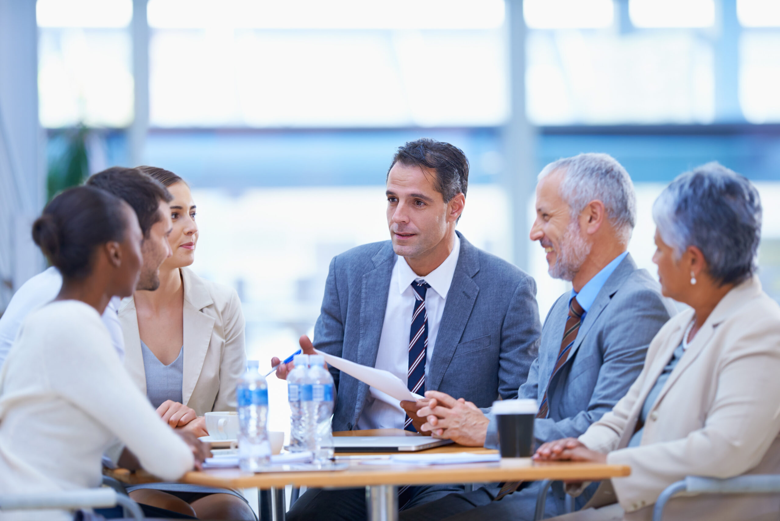 Diverse group of business professionals engaged in discussion.