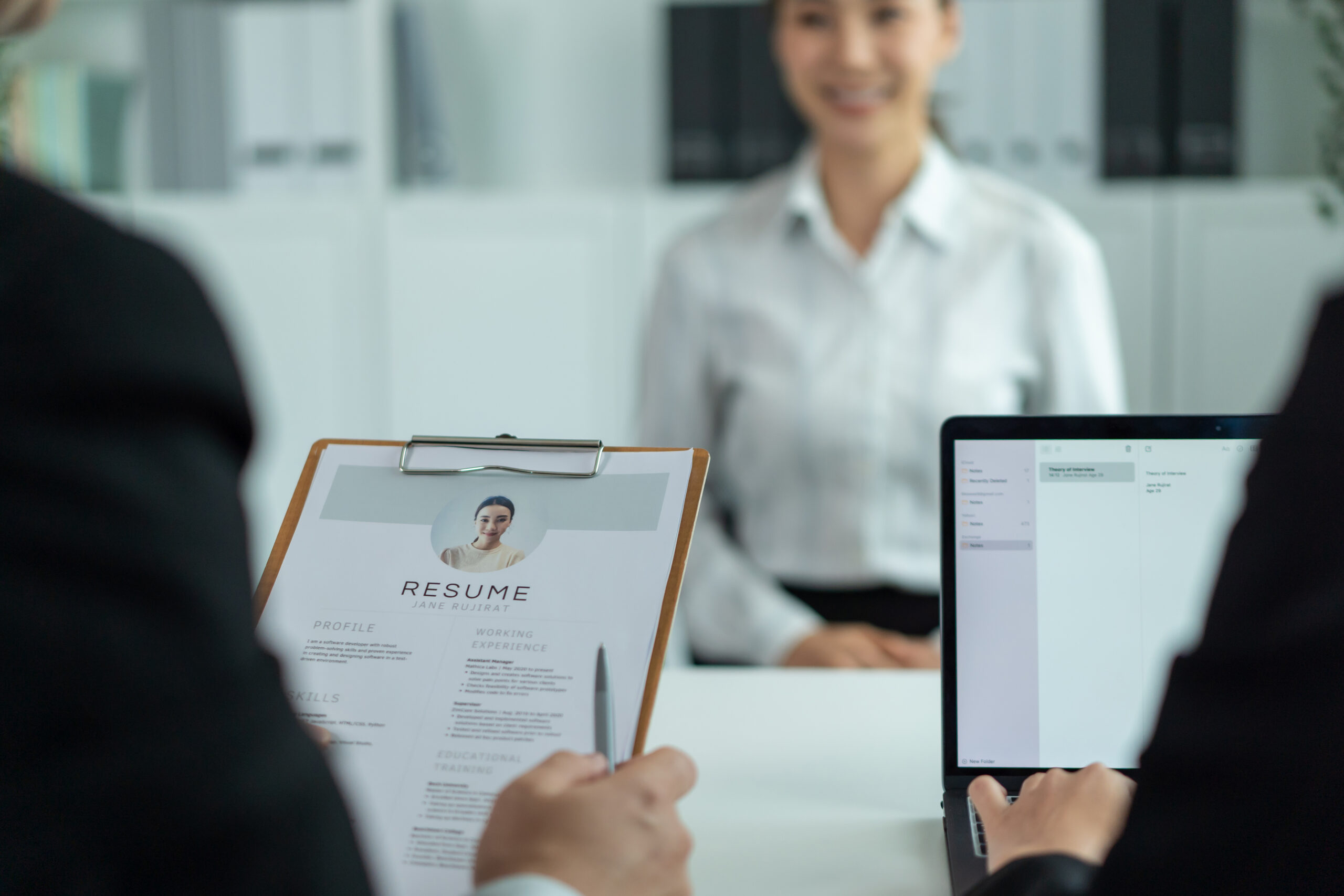 A hiring manager reviewing an applicant’s resume during an interview.